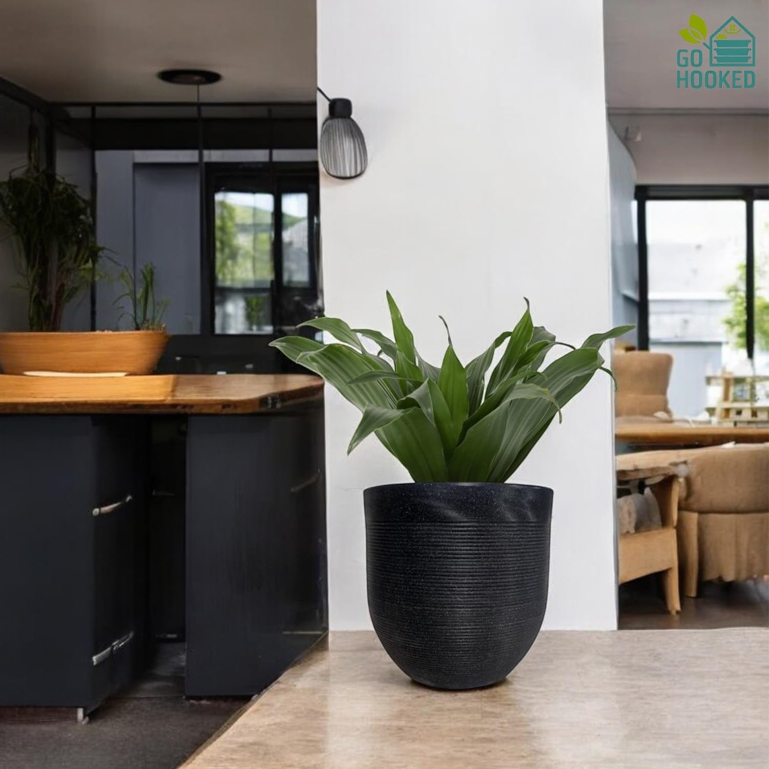 GoHooked 12 inch round grey polymer plant pot with textured finish, holding a green plant.