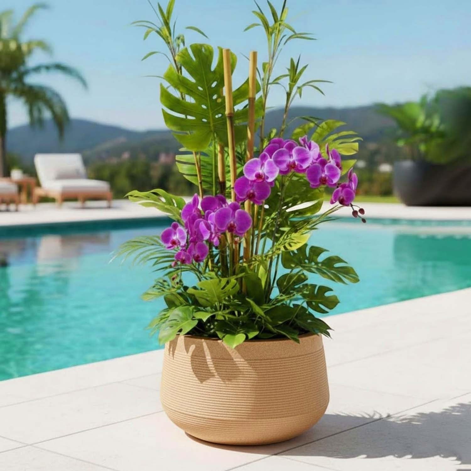 Go Hooked 15 inch round beige textured polymer plant pot with purple orchids and green foliage by a pool.