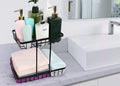 GoHooked black metal 2-tier countertop organizer basket holding toiletries and folded towels next to a sink.