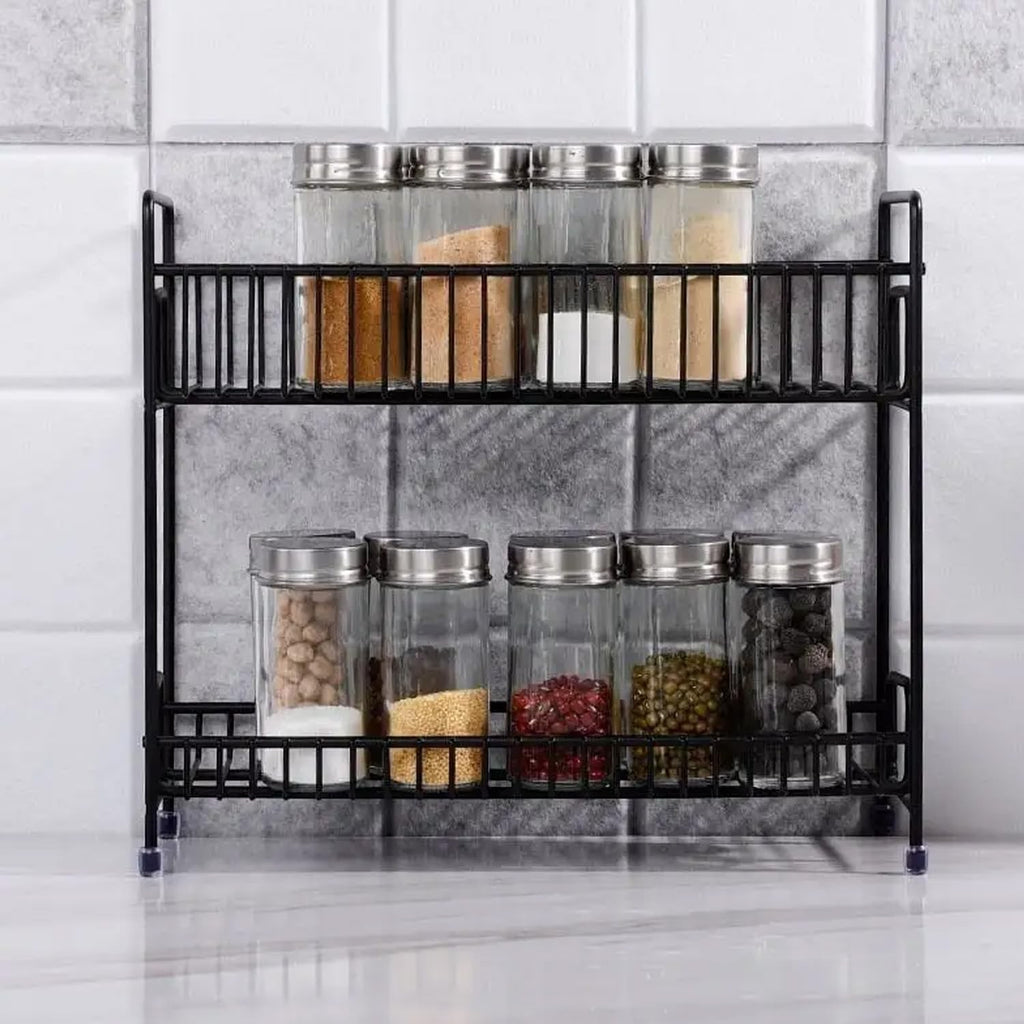 Go Hooked black 2-tier iron spice rack organizer filled with jars of spices and condiments.