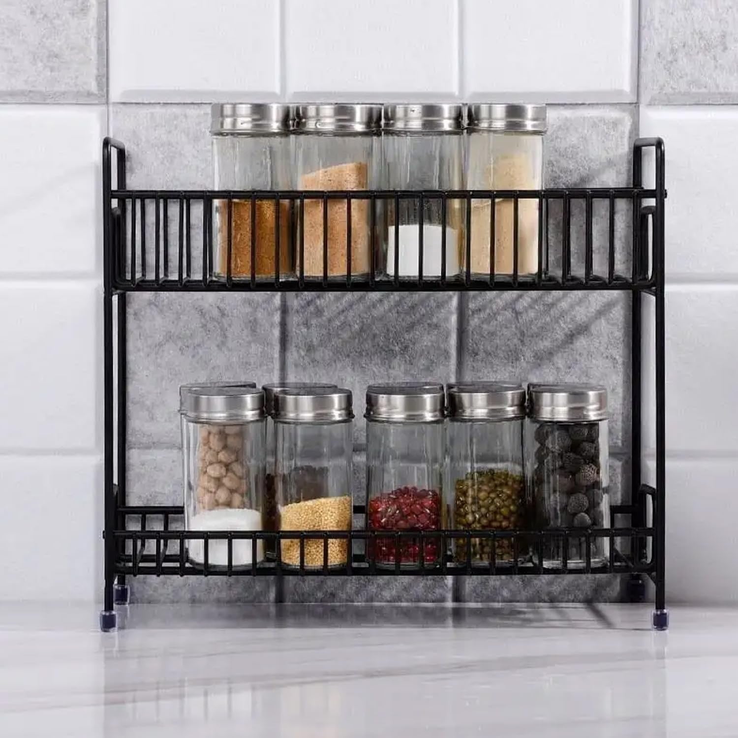 Go Hooked black 2-tier iron spice rack organizer filled with jars of spices and condiments.