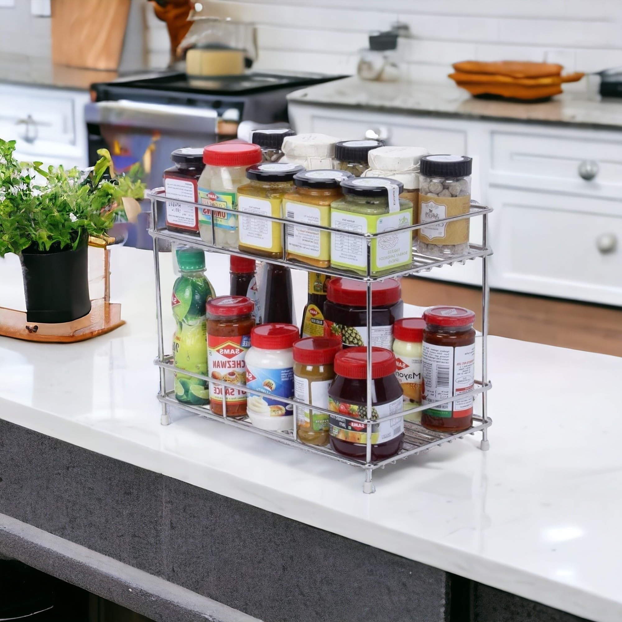 GoHooked 2-tier stainless steel multipurpose shelf basket with various jars and bottles on kitchen counter.