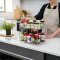 GoHooked 2-tier stainless steel multipurpose shelf basket organizer filled with spice jars and condiments on a kitchen counter.