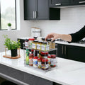GoHooked 2-tier stainless steel spice rack organizer filled with jars and bottles on a kitchen counter.