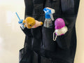 GoHooked black 20-pocket non-woven fabric door organizer with clear pockets holding a teddy bear, spray bottle, and a water bottle.