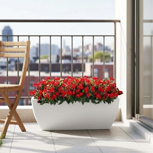 Go Hooked 24-inch black rectangular polymer planter pot filled with red flowers on a balcony.