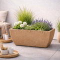 GoHooked 36-inch brown rectangular polymer planter pot with drainage hole, filled with ornamental grasses, white flowers, and lavender.
