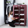 Go Hooked burgundy 6-tier folding shoe rack with wardrobe cover, holding folded clothes.