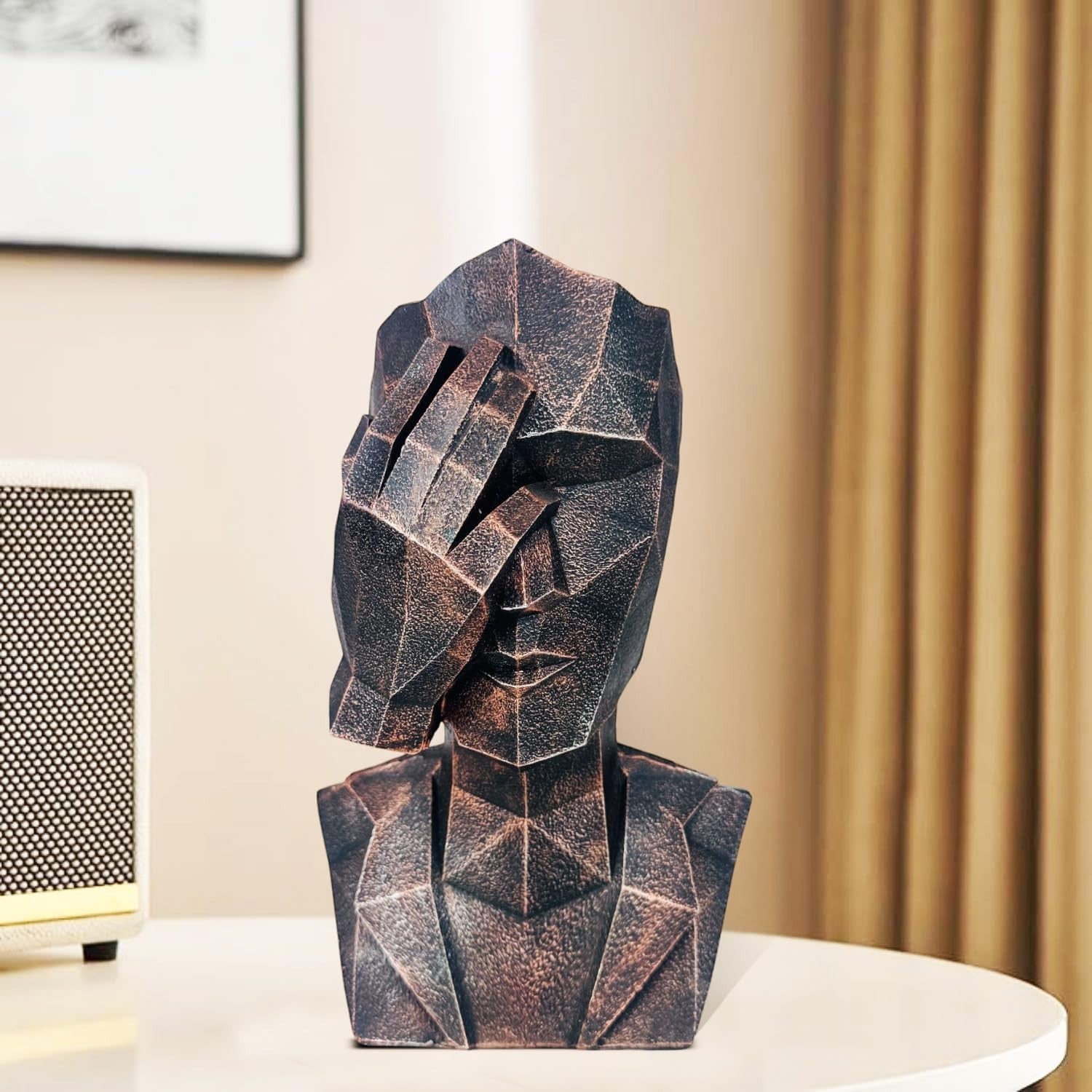 GoHooked abstract geometric polyresin showpiece in black copper finish, depicting a face covering its ears.