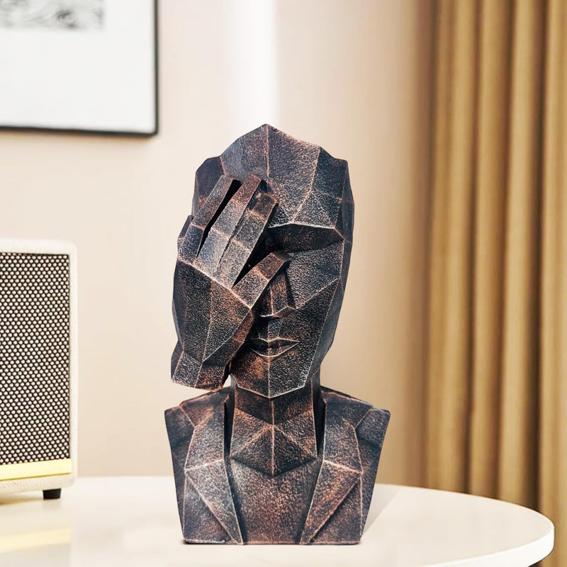 GoHooked abstract geometric polyresin showpiece in black copper finish, depicting a face covering its ears.