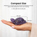Go Hooked natural amethyst crystal tortoise decorative showpiece held in a hand, 7.5 cm long.