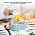 GoHooked aqua blue rectangular cotton rope storage basket with PU leather handles, filled with gifts and wrapped in cellophane.