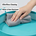 GoHooked aqua blue round metal storage tray with perforated sides being wiped clean with a grey cloth. Water & rust resistant.