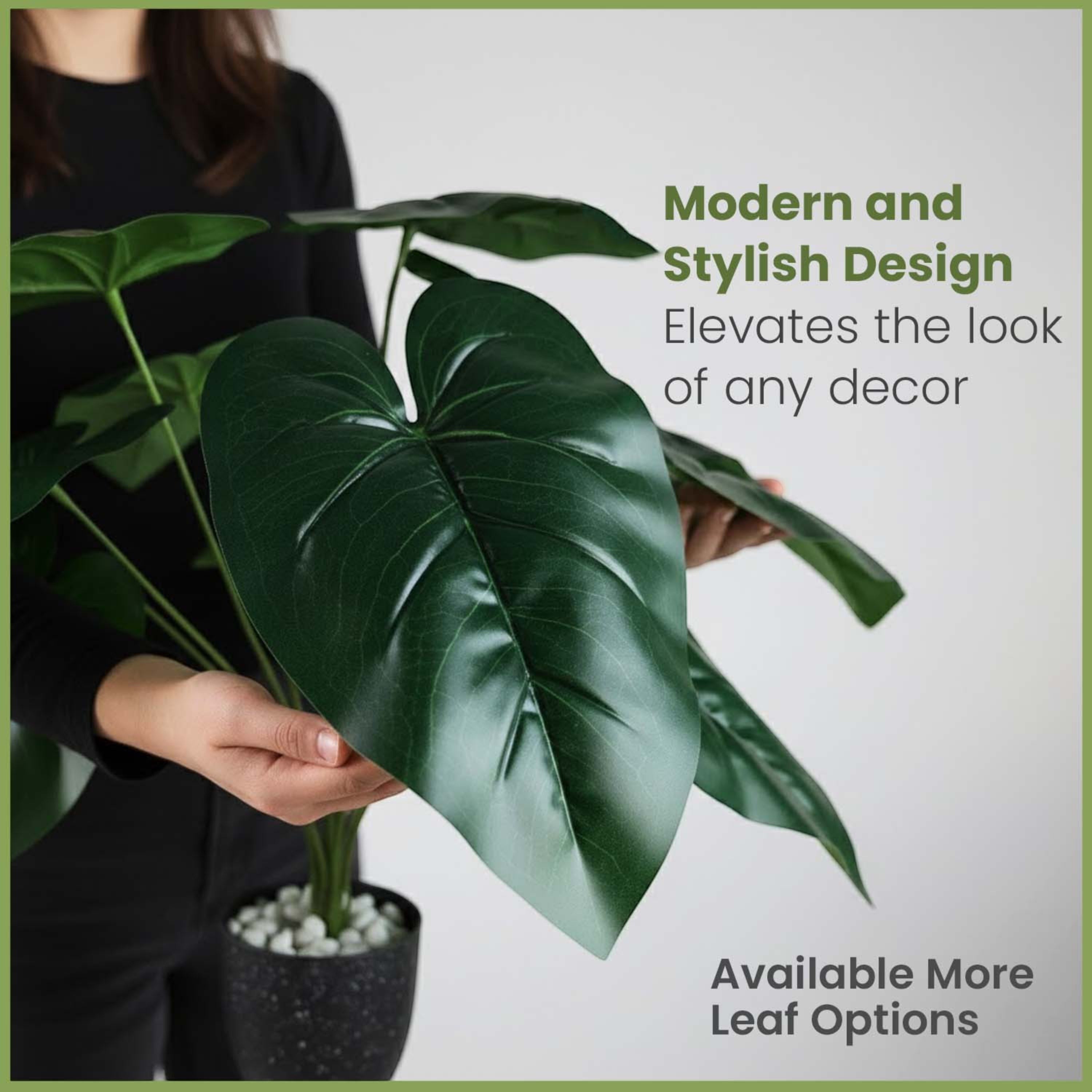 GoHooked artificial Alocasia plant with large green leaves in a speckled pot held by a person in a black shirt