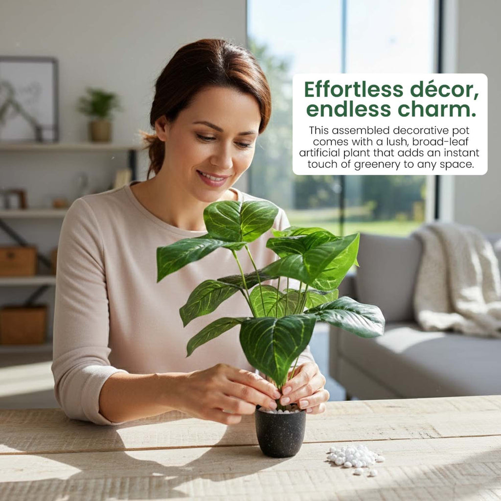 GoHooked artificial Alocasia plant with green leaves in a small pot being arranged by a woman on a wooden table