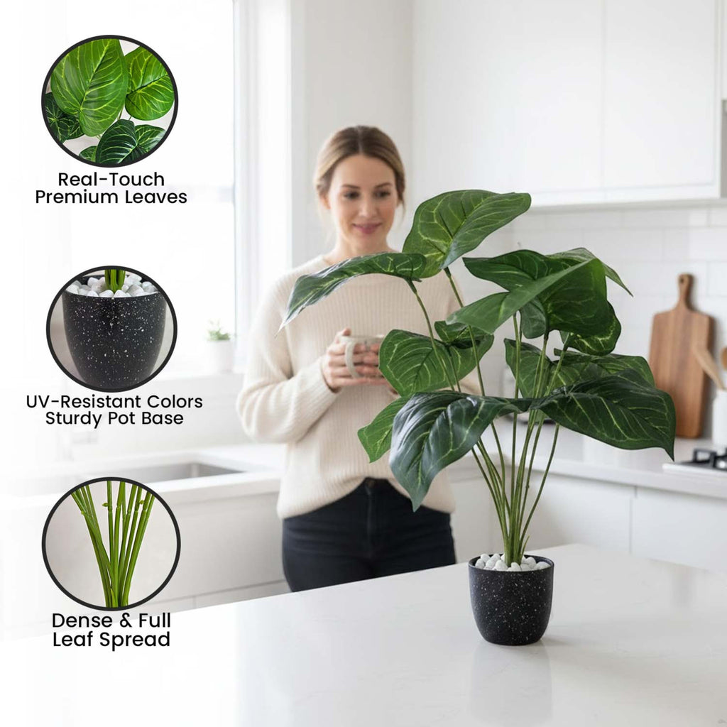 GoHooked artificial Alocasia plant with green leaves in a black speckled pot on a white kitchen counter