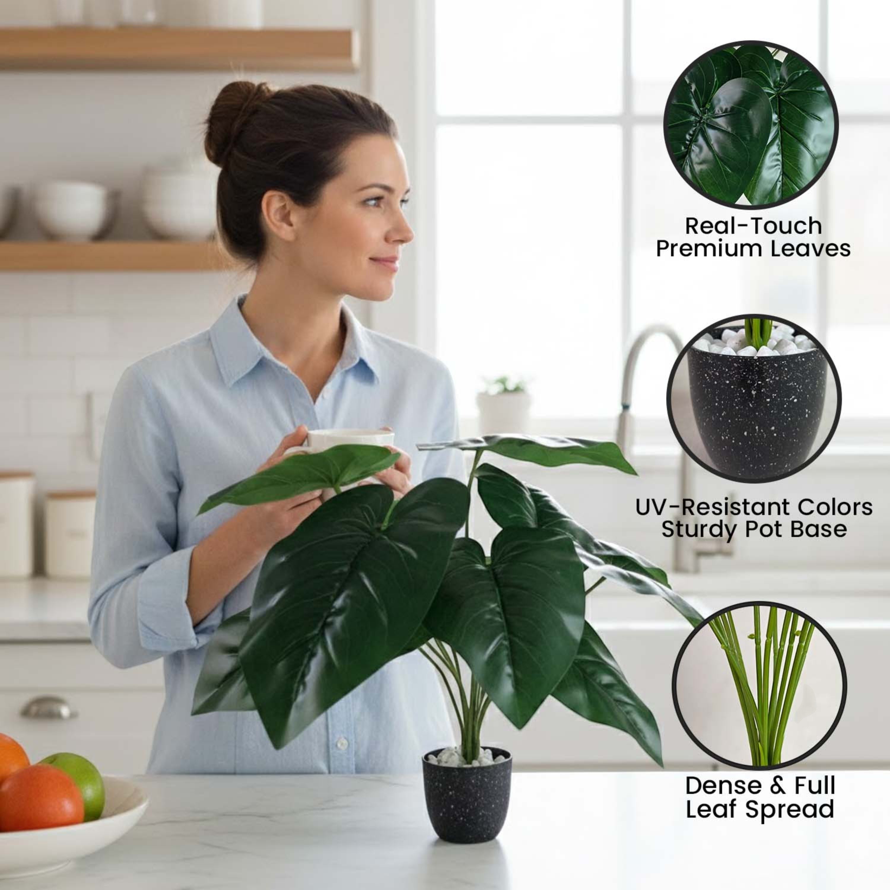 GoHooked artificial Alocasia plant with green leaves in a speckled pot, displayed on a kitchen counter by a woman.