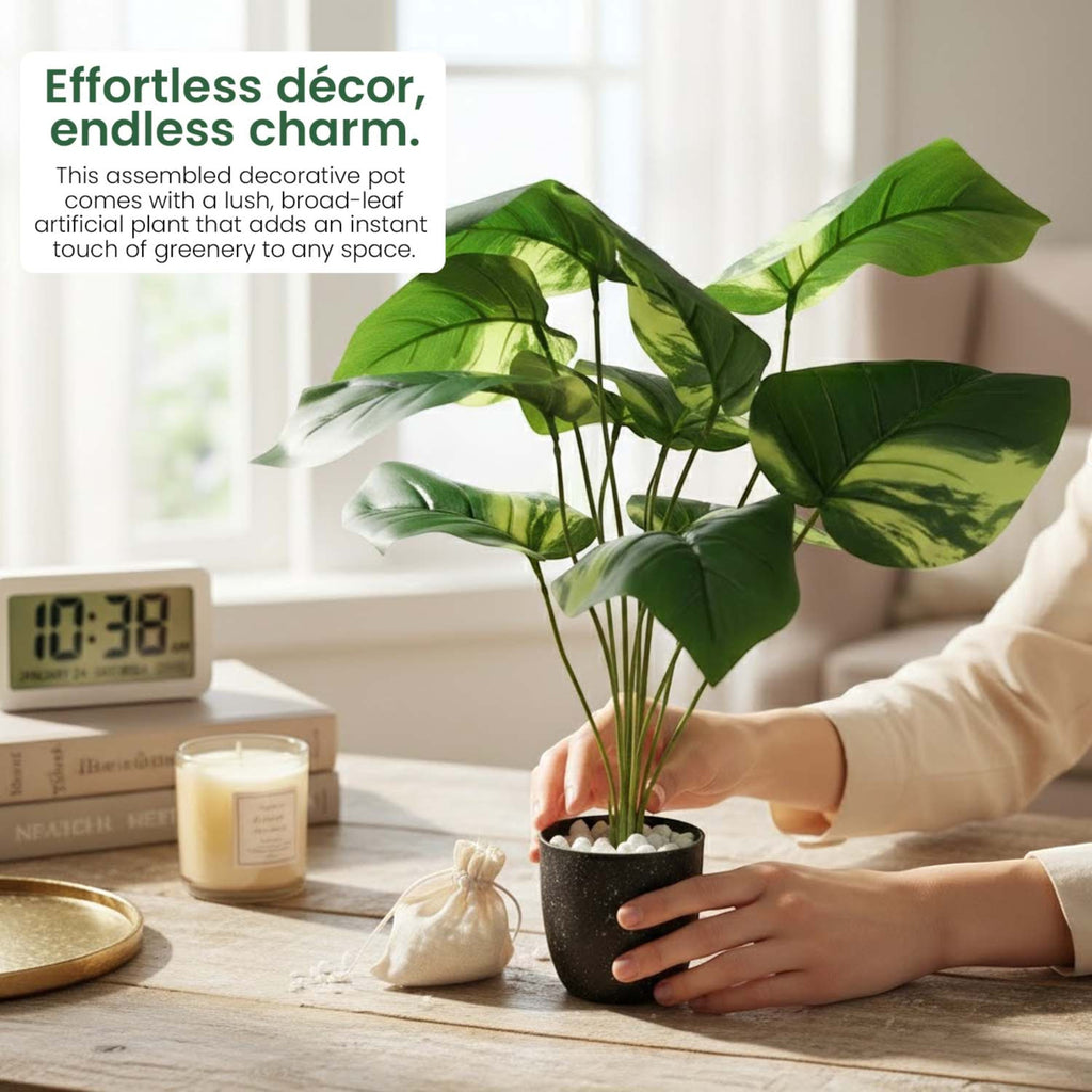 GoHooked artificial Alocasia plant in a black pot with white pebbles, featuring lush green leaves on a wooden desk.