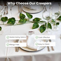Go Hooked green arrowhead leaf artificial creeper garland draped over a formal table setting with wine glasses and plates.
