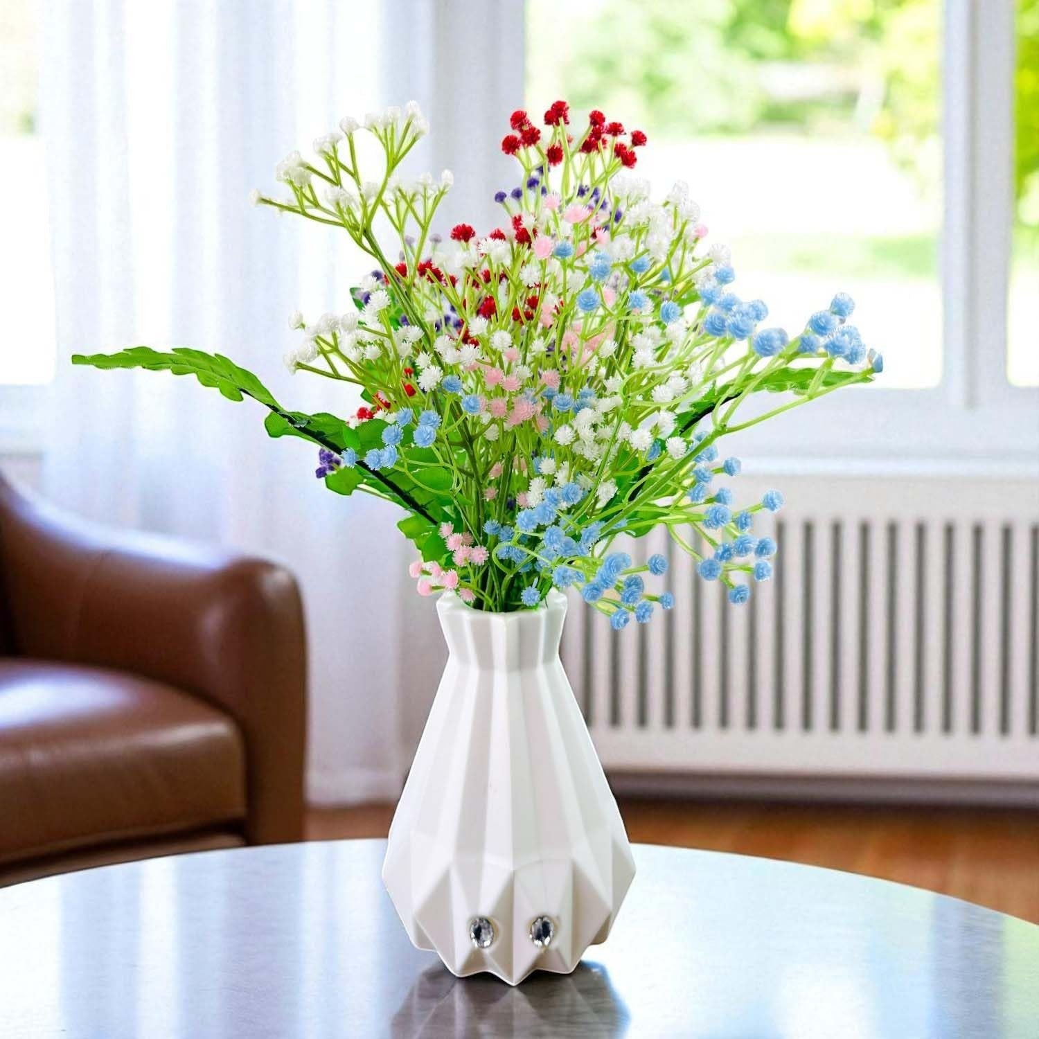 Go Hooked multicolor artificial baby's breath flowers with fern leaves in a white geometric vase.
