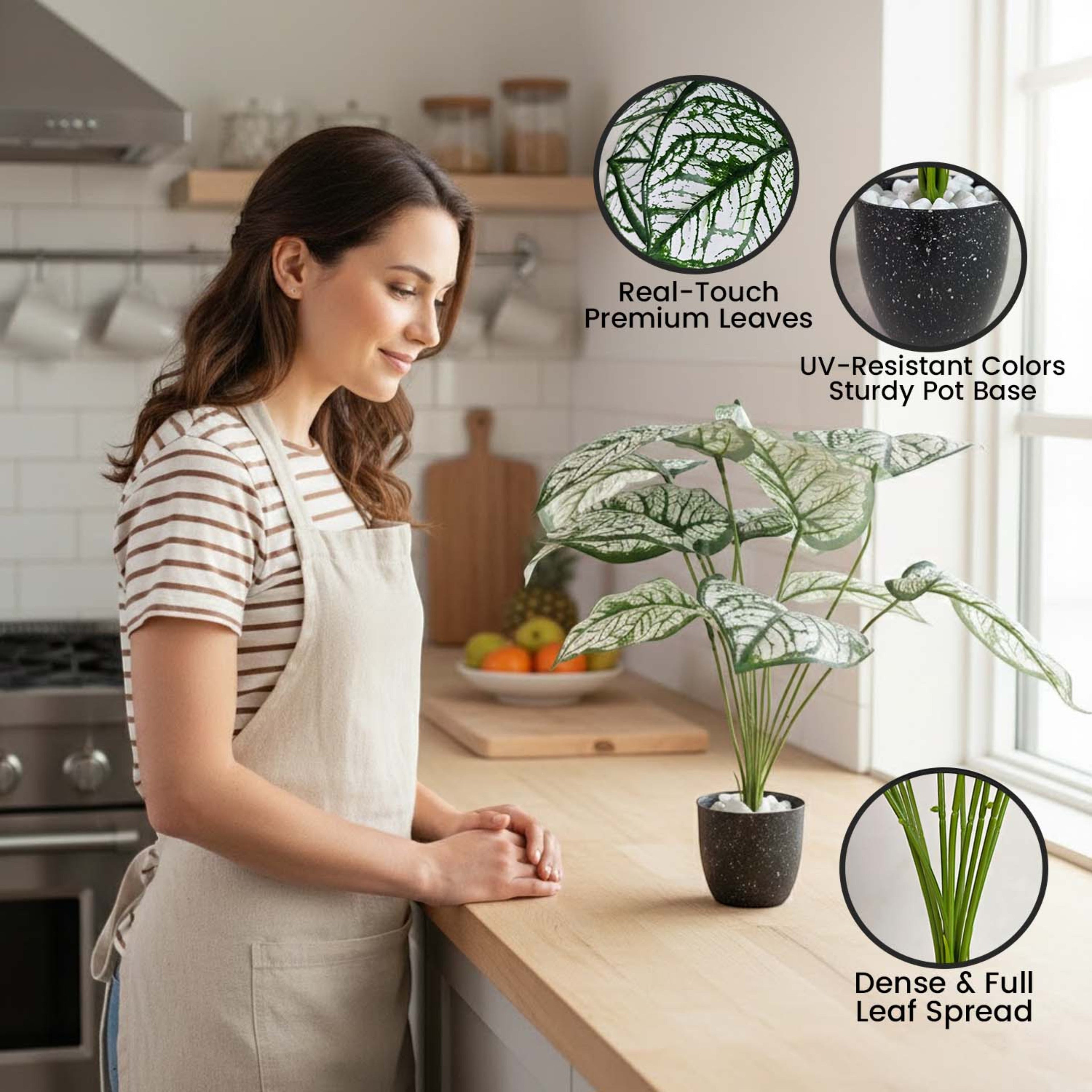 GoHooked artificial Caladium Bicolor plant with patterned green leaves in a black pot on a kitchen counter.