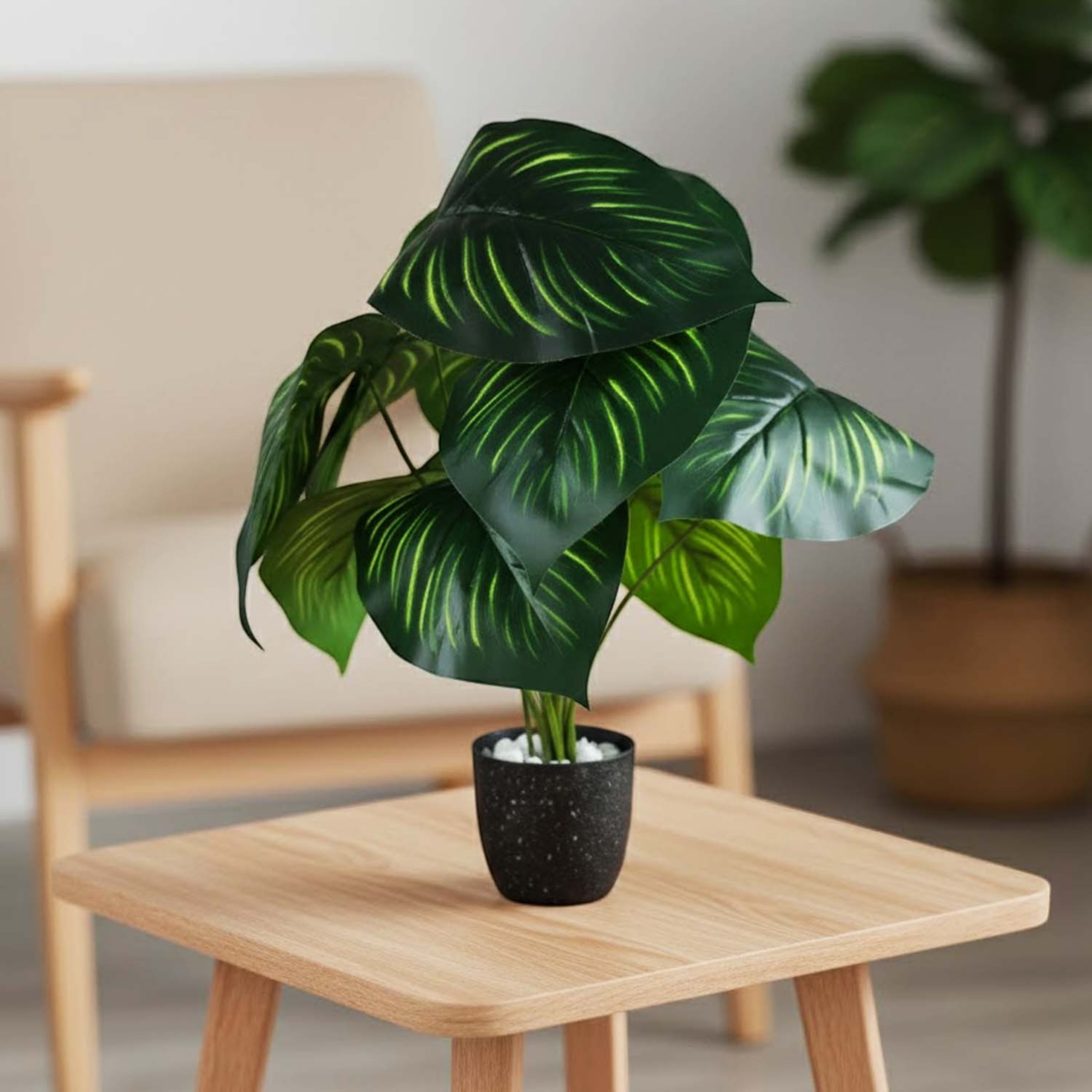 GoHooked artificial Calathea Orbifolia plant with green patterned leaves in a black pot on a wooden side table.
