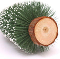 GoHooked 12-inch artificial pine Christmas tree with snow-tipped branches and a natural wood base.