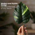 GoHooked artificial Dieffenbachia leaf with realistic green and yellow variegated texture held by a hand