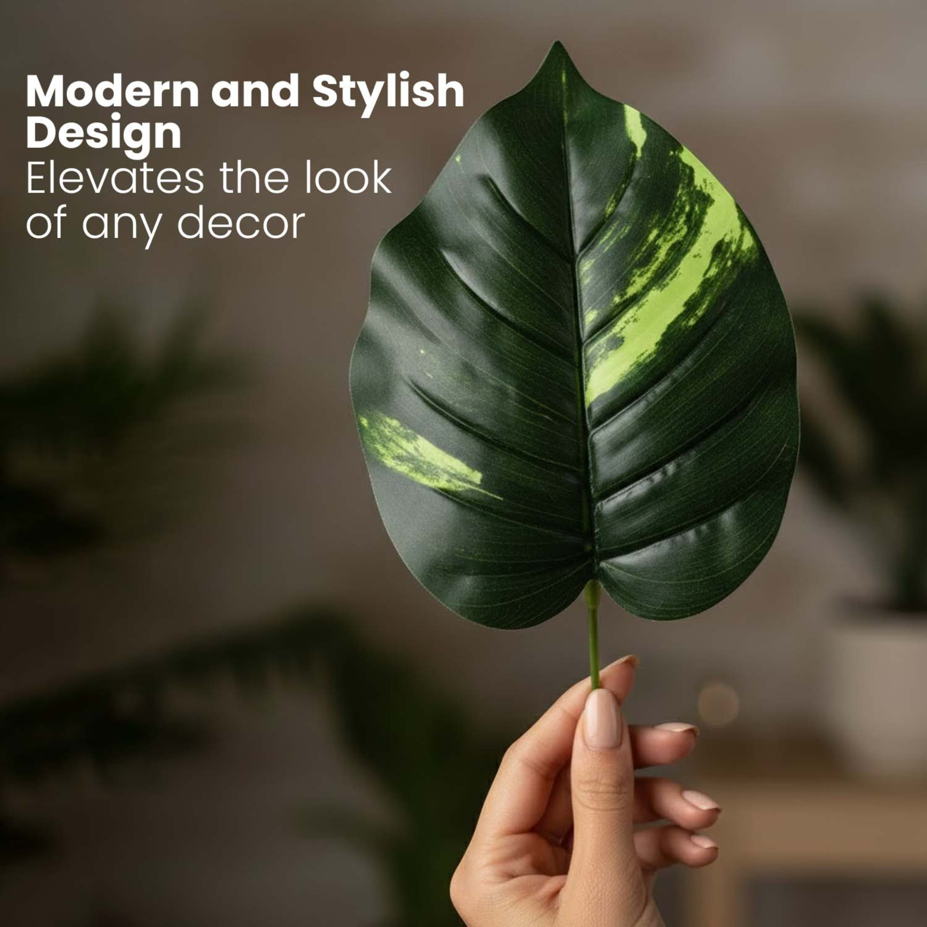 GoHooked artificial Dieffenbachia leaf with realistic green and yellow variegated texture held by a hand