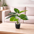 GoHooked artificial Dieffenbachia plant with 12 green and yellow patterned leaves in a speckled black pot with white pebbles.