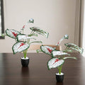 GoHooked set of 2 artificial Epipremnum Aureum plants with white and red patterned leaves in black pots with white pebbles.