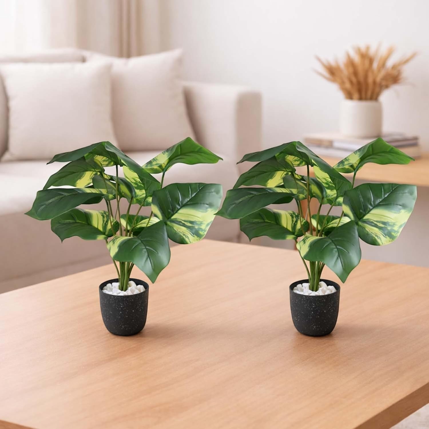 GoHooked set of 2 artificial Epipremnum Aureum plants with variegated green leaves in speckled black pots topped with white pebbles.