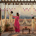 GoHooked white artificial mogra flower garlands with pink lotus buds, decorating a balcony for a festive occasion.