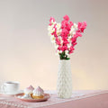 Go Hooked artificial pink and white flowers in a textured white vase, a decorative floral arrangement for home or office.