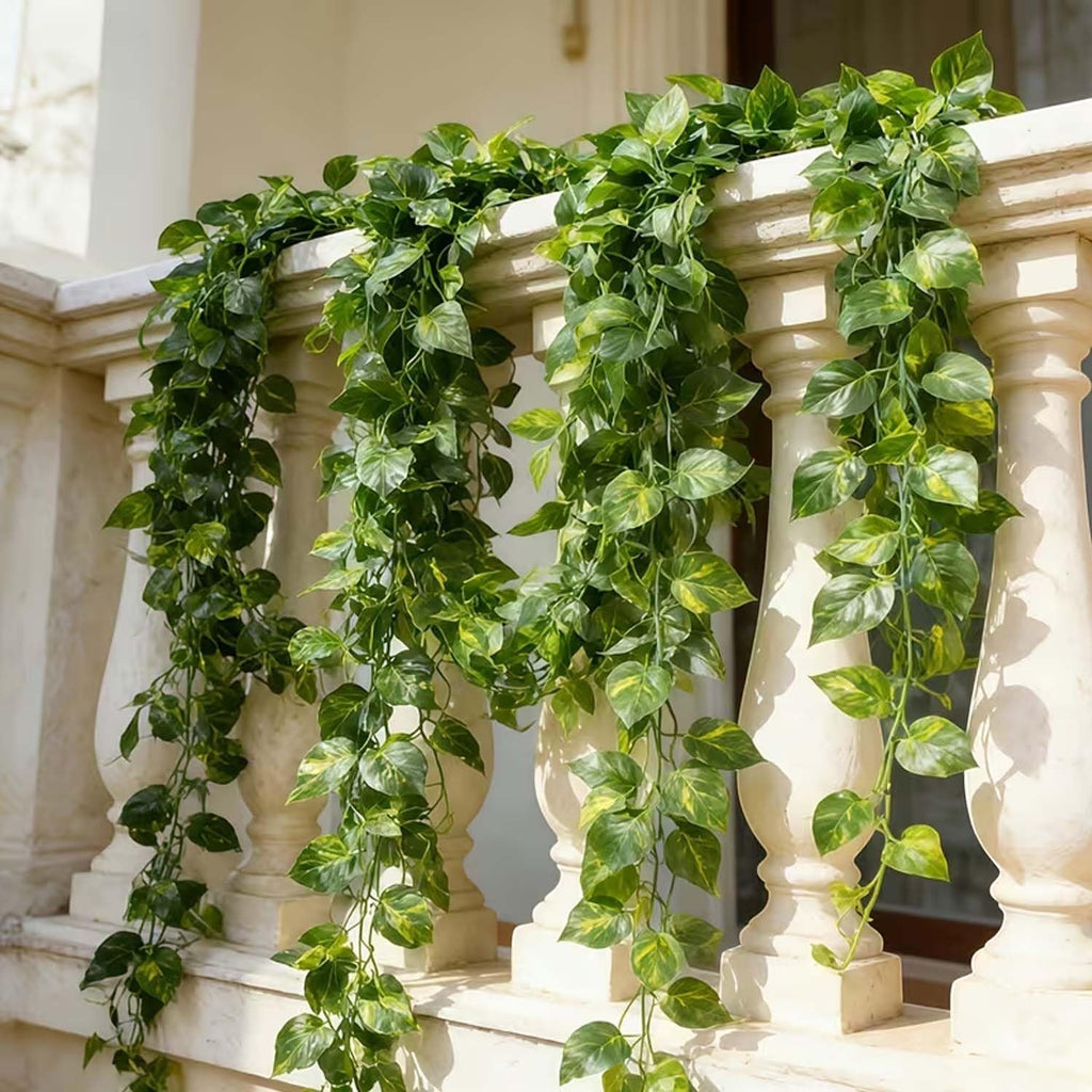Go Hooked artificial money plant creeper garland with green and yellow variegated leaves, 6 ft long, draped over a balcony railing.