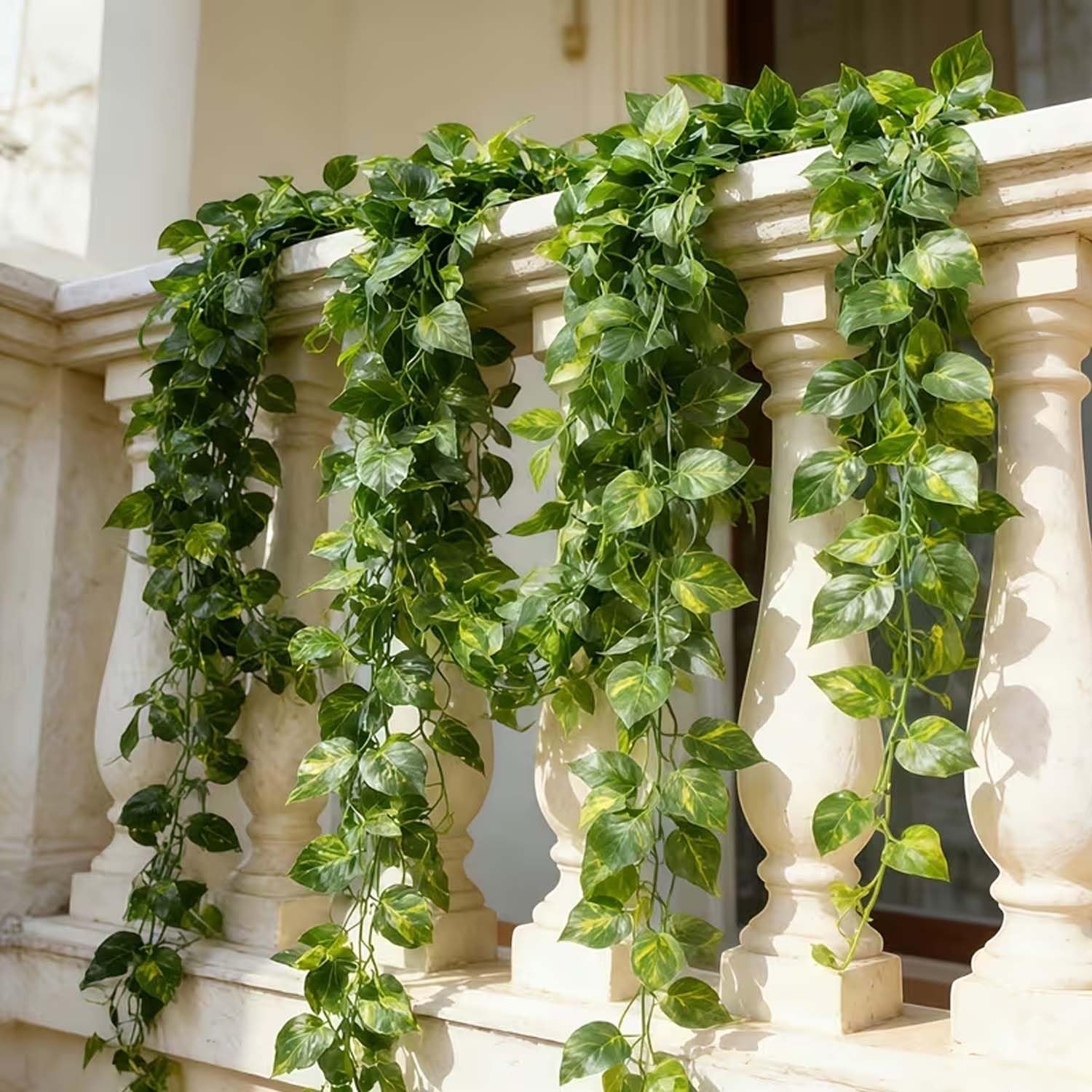 Go Hooked artificial money plant creeper garland with green and yellow variegated leaves, 6 ft long, draped over a balcony railing.