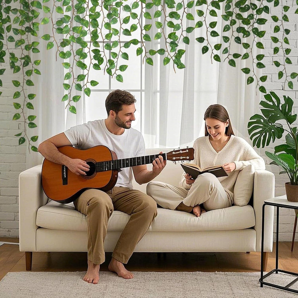 GoHooked artificial money plant hanging creepers decorating a living room with a couple sitting on a white sofa
