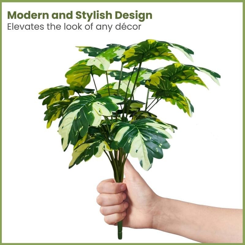 GoHooked artificial Monstera Deliciosa plant with 18 variegated green and cream leaves, held by a hand.