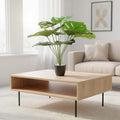 Go Hooked artificial Monstera plant with 12 green leaves in a speckled pot with white pebbles, placed on a coffee table.