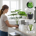 Go Hooked artificial Monstera plant with 12 patterned polyester leaves in a speckled black pot with white pebbles. Realistic greenery for home decor.