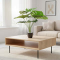GoHooked artificial monstera plant with green leaves in a decorative pot with pebbles on a wooden coffee table.
