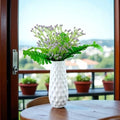 GoHooked artificial purple baby's breath flowers in a white textured vase, realistic rubber flower heads and plastic stems.