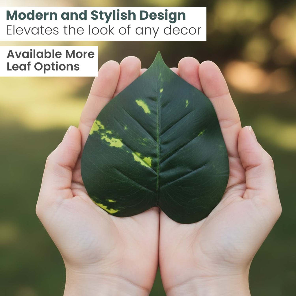 Hands holding a realistic GoHooked artificial green leaf with yellow variegation for home decor