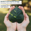 Hands holding a realistic GoHooked artificial green leaf with yellow variegation for home decor