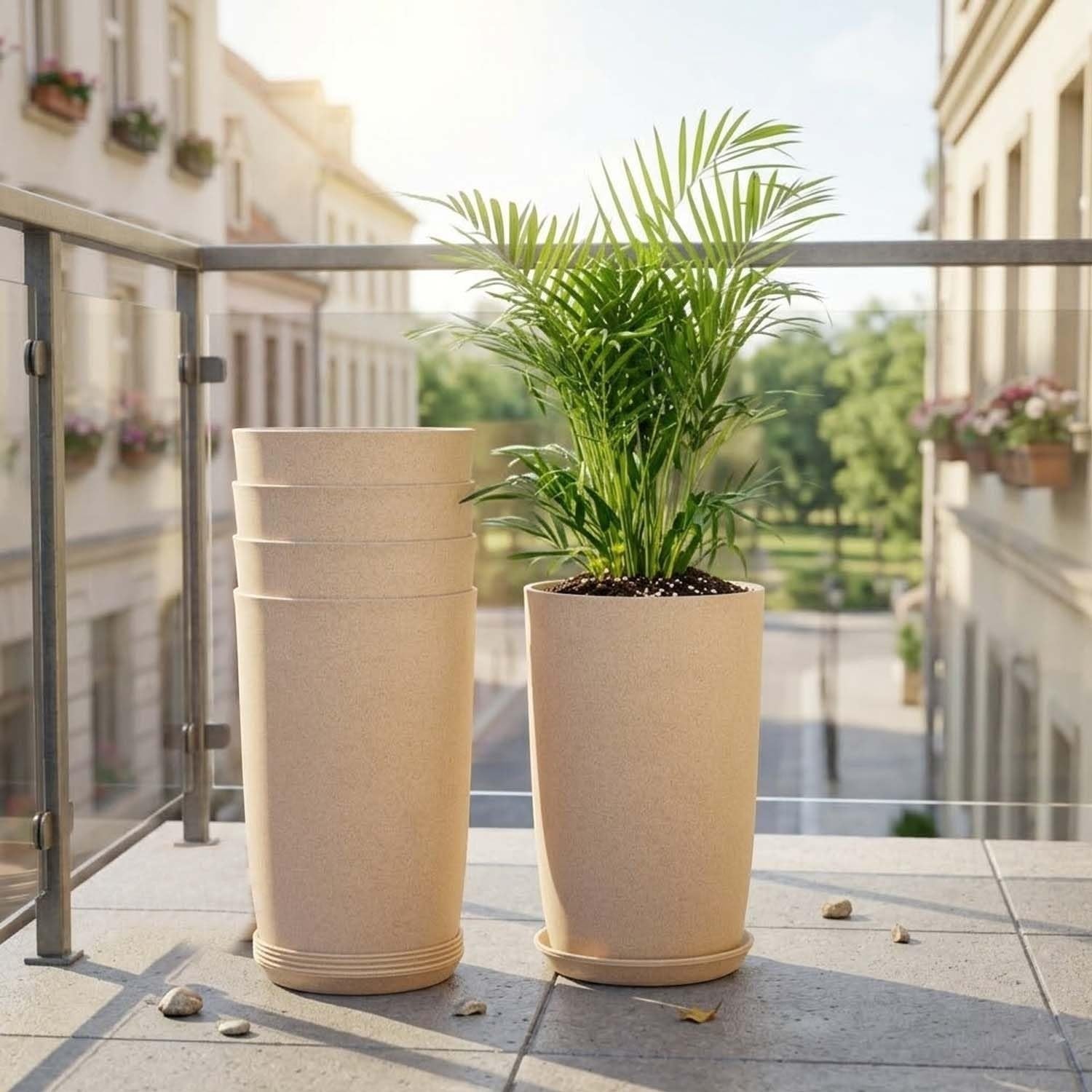 GoHooked set of 3 beige speckled plastic planters, one with a palm plant, on a balcony.