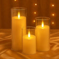 GoHooked BIANCO set of 3 golden acrylic LED tea light candles with realistic flickering flames in glass holders.