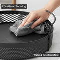 GoHooked Bianco black round metal storage tray with perforated sides and side handles, being wiped clean. Water & rust resistant.