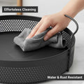 GoHooked Bianco black round metal storage tray with perforated sides and side handles, being wiped clean.