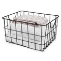GoHooked Bianco black steel wire storage basket with curved handles, holding folded white and patterned towels.
