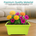 GoHooked Bianco green rectangular plastic plant pot filled with yellow, pink, and orange flowers.